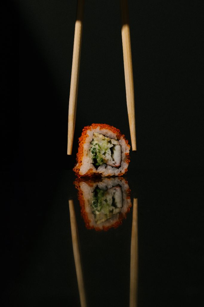 Signature sushi roll with chopsticks
